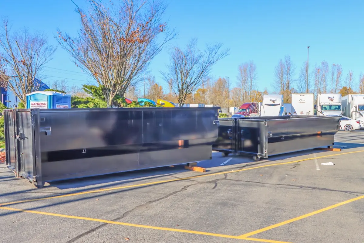 Professional dumpster rental service with roll-off container on residential driveway in Mahwah